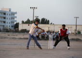 جالية من الهنود يلعبون الكريكيت في احد الساحات في سترة